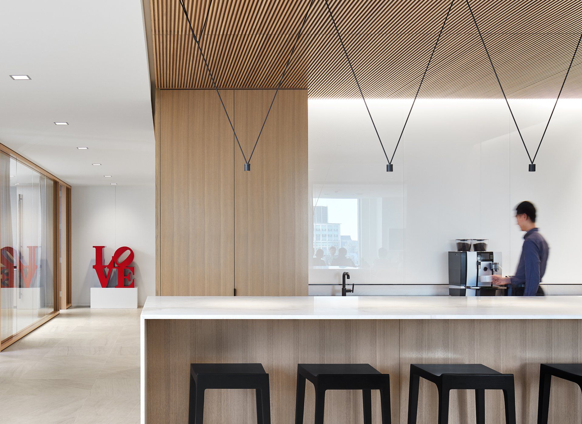 A man is standing at a counter in a kitchen.