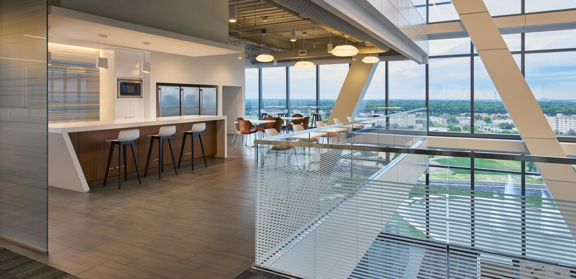 A large room with a lot of windows and stools.