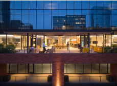 An aerial view of a building with a balcony at night