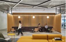 A group of people are sitting on a couch in a living room.