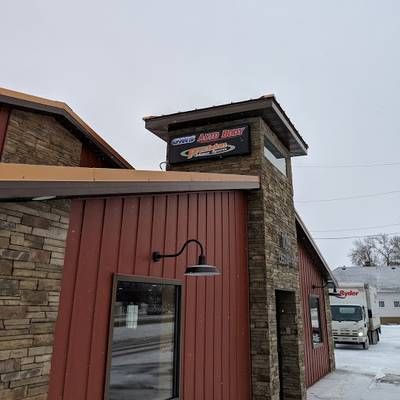 A red building with a sign on top of it.