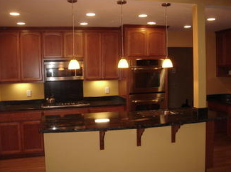 A kitchen with stainless steel appliances and wooden cabinets