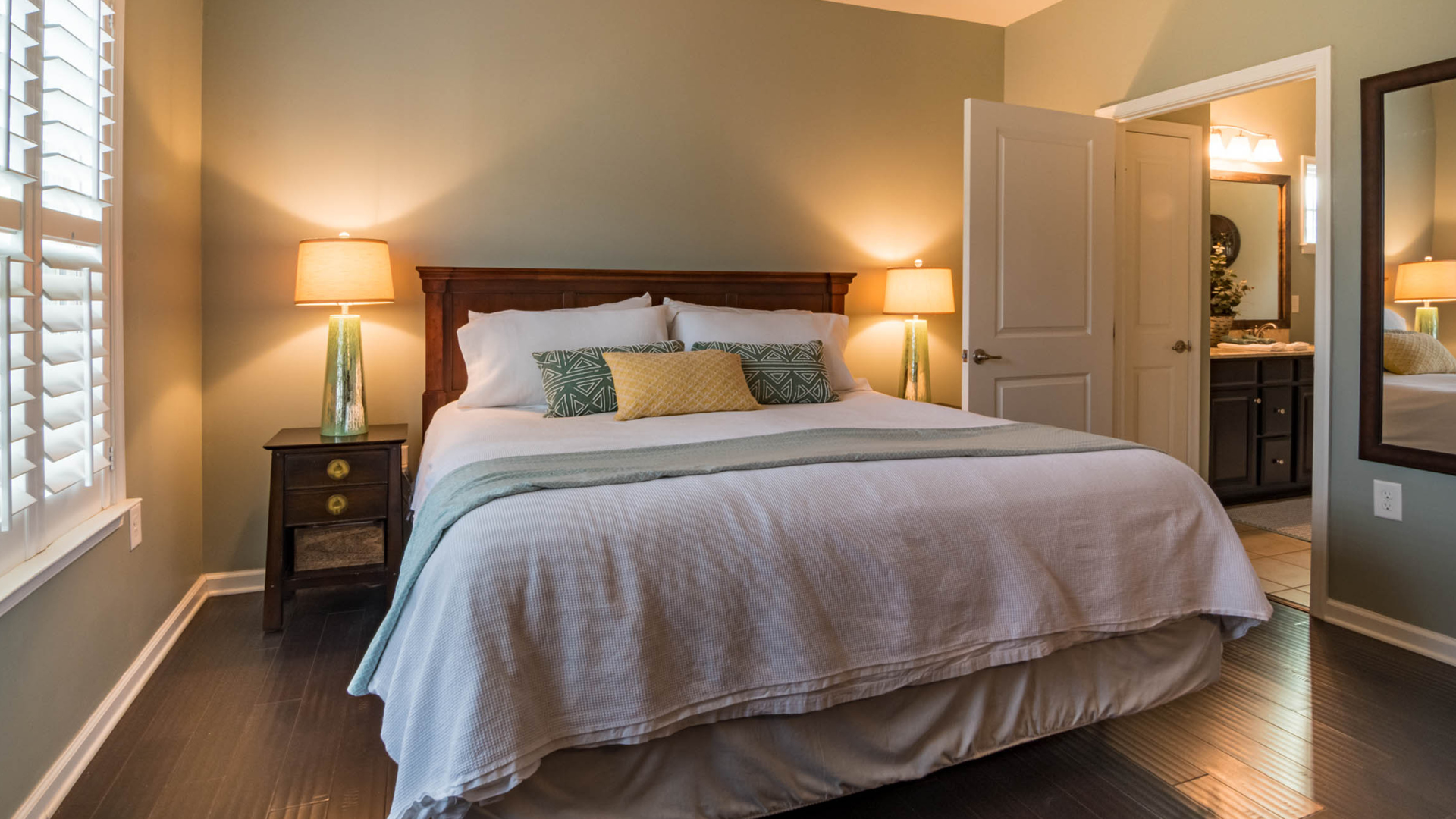 A house with a deck and stairs in front of it