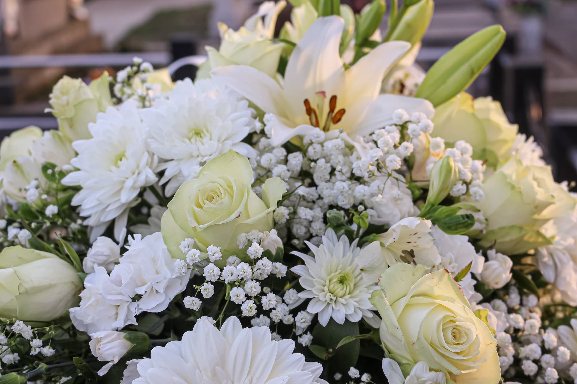 A close up of a bouquet of white flowers on a table.