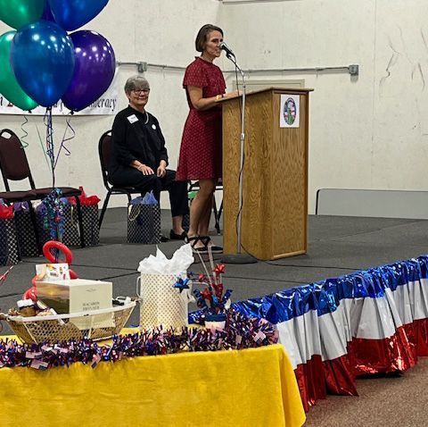A statue of liberty holding a torch on a blue background