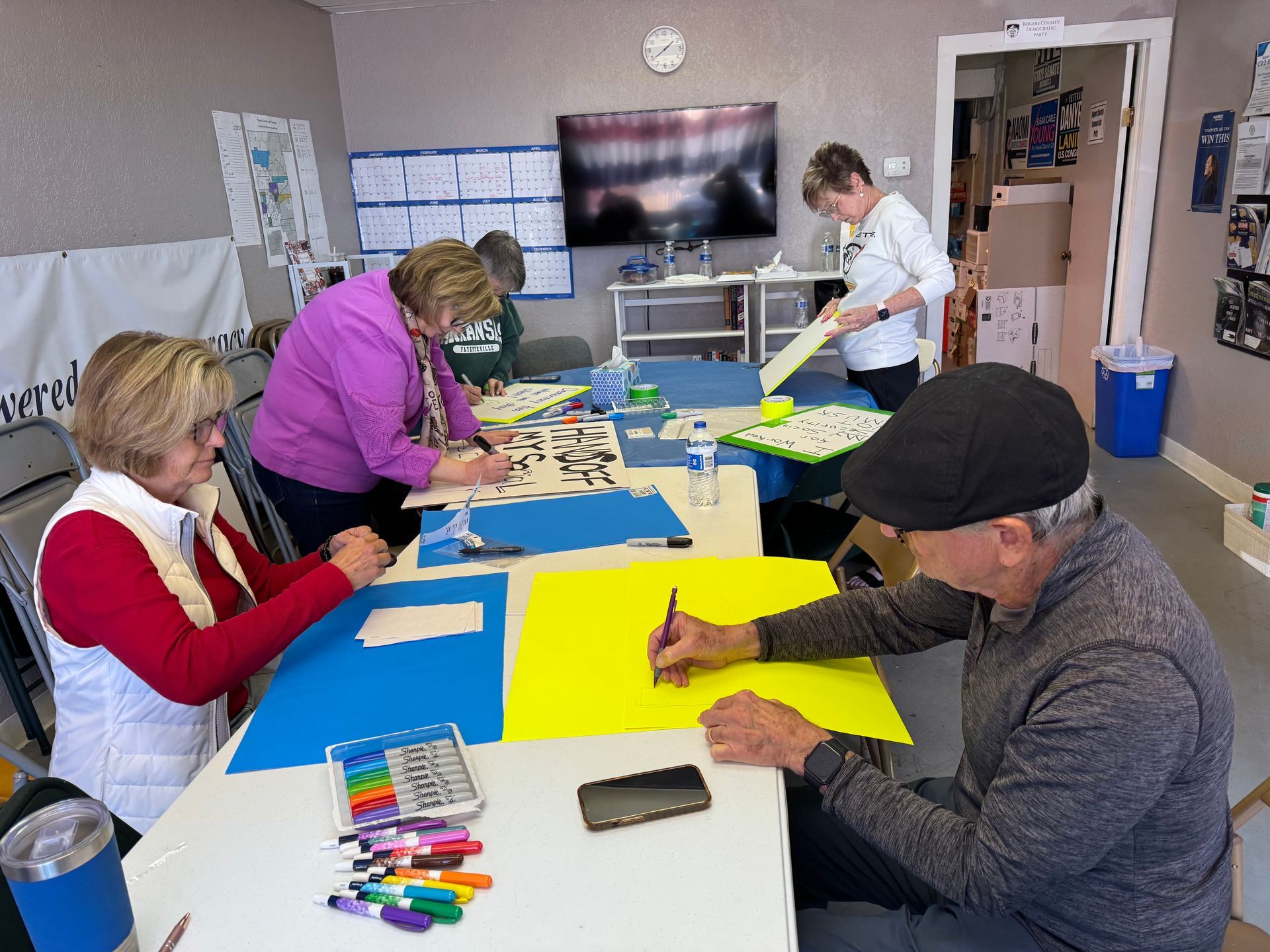 WE members making protest signs at our downtown Claremore office.