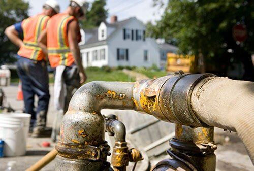 Plumber checking the pipe system — Plumbing in Michigan