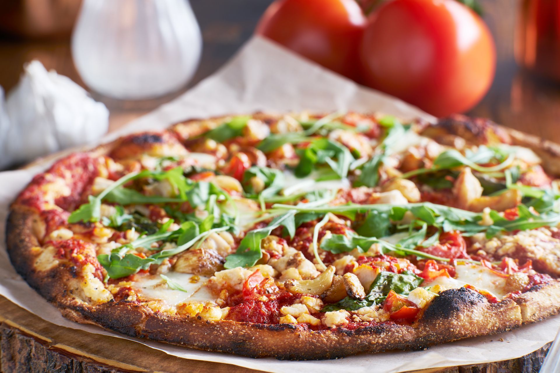 A pizza is sitting on top of a wooden cutting board.