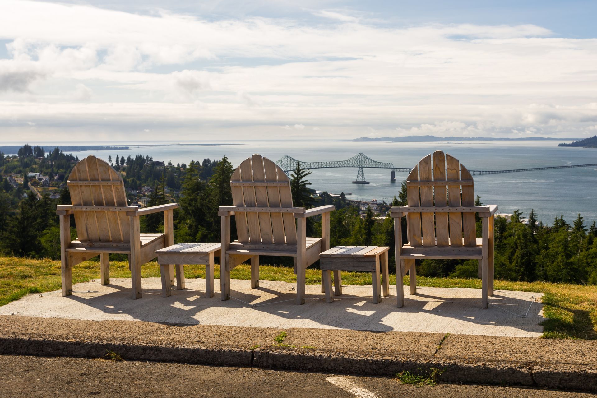 A row of wooden chairs with a view of the ocean
