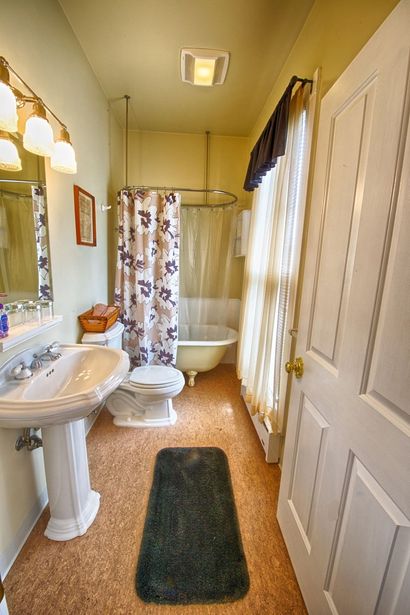 A bathroom with a sink , toilet , tub and mirror