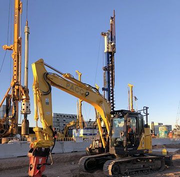 A yellow excavator with the word pacco on it