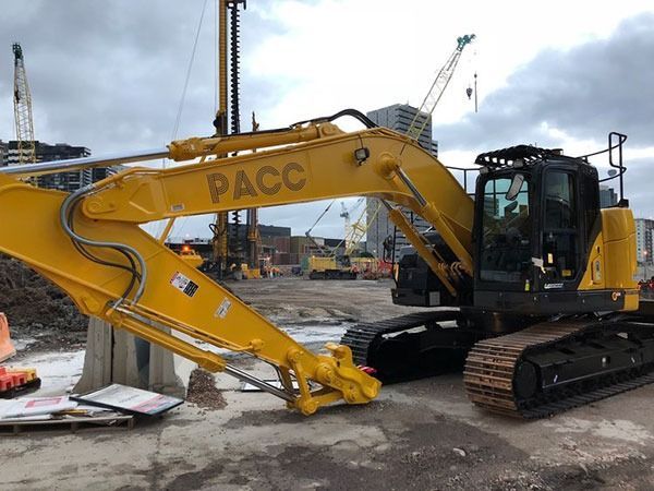 A yellow excavator is parked on a construction site.