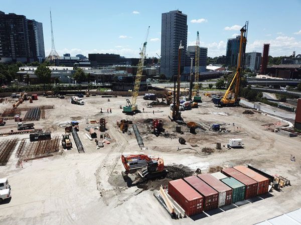 An aerial view of a construction site with containers and cranes