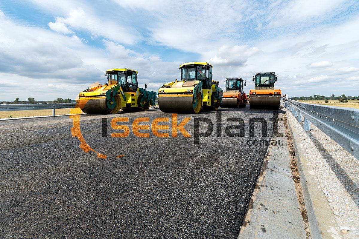 A group of rollers are lined up on the side of a road.