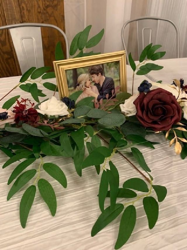 There is a picture of a bride and groom in a frame on the table.