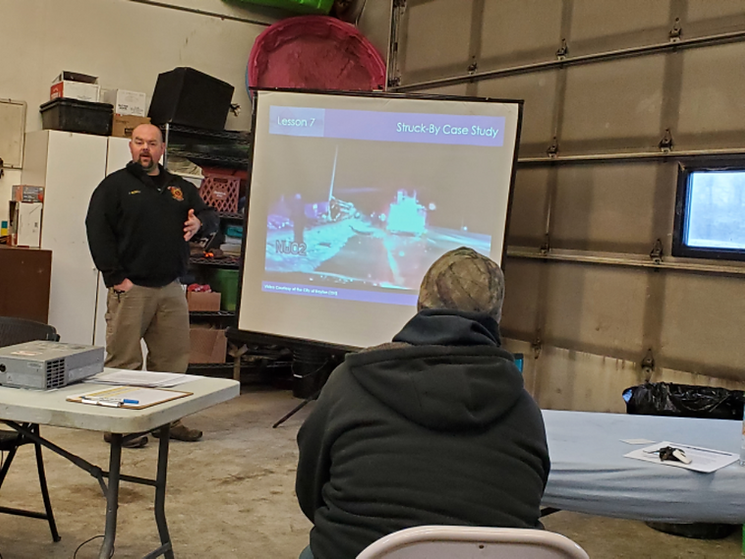 A man is giving a presentation to a group of people