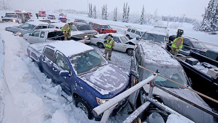 A lot of cars are stuck in the snow.