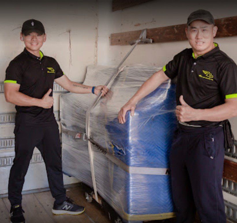 Two men giving a thumbs up in front of a blue box