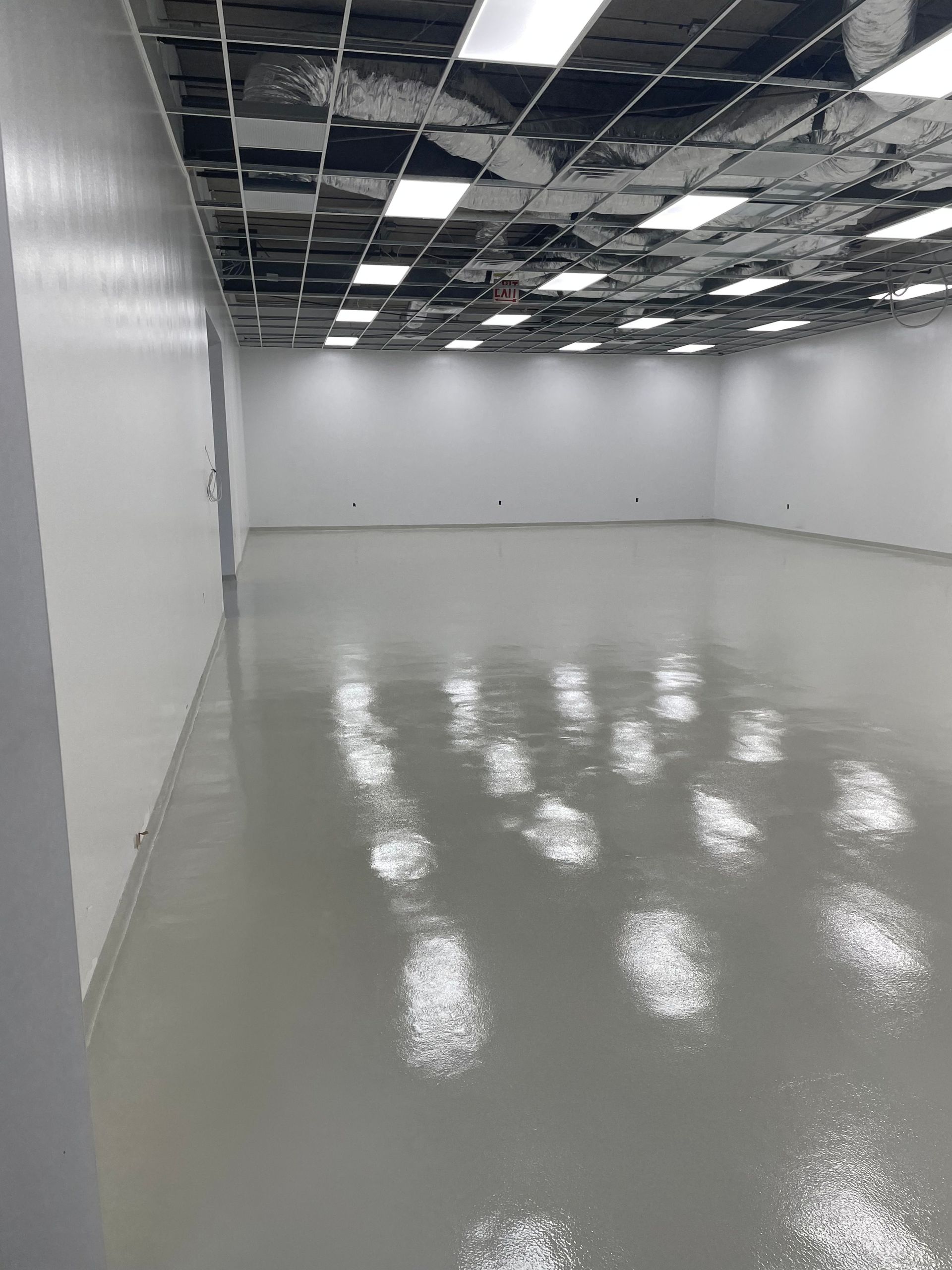 A large empty room with a shiny floor and white walls.