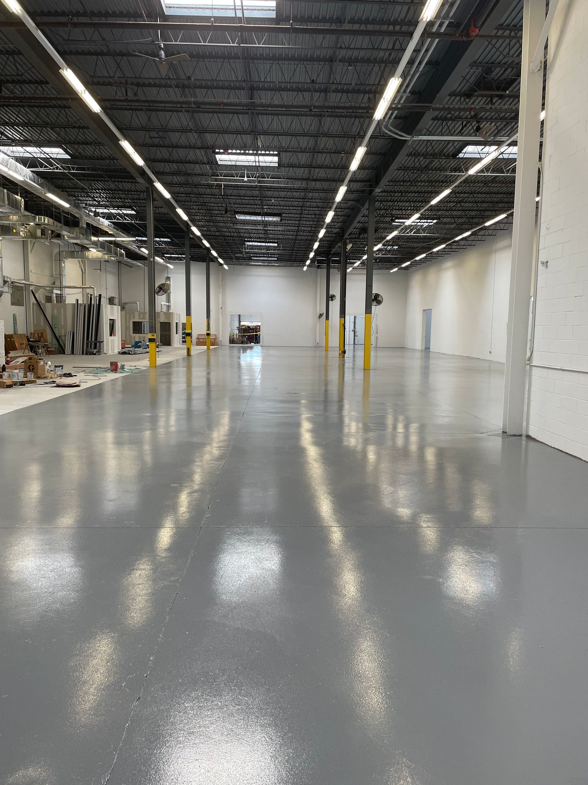 A large empty room with a shiny floor and white walls.