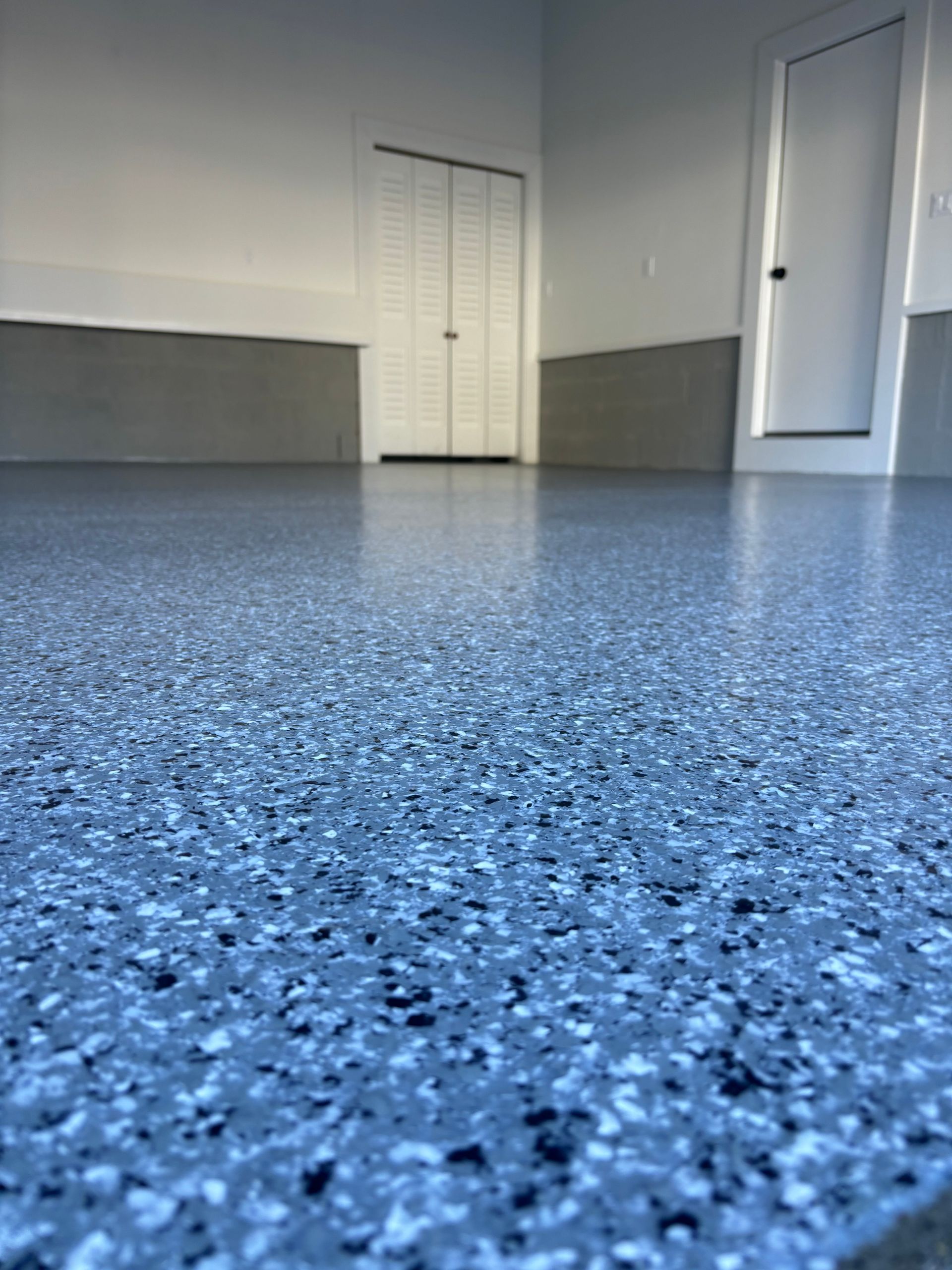A close up of a blue floor in a garage.