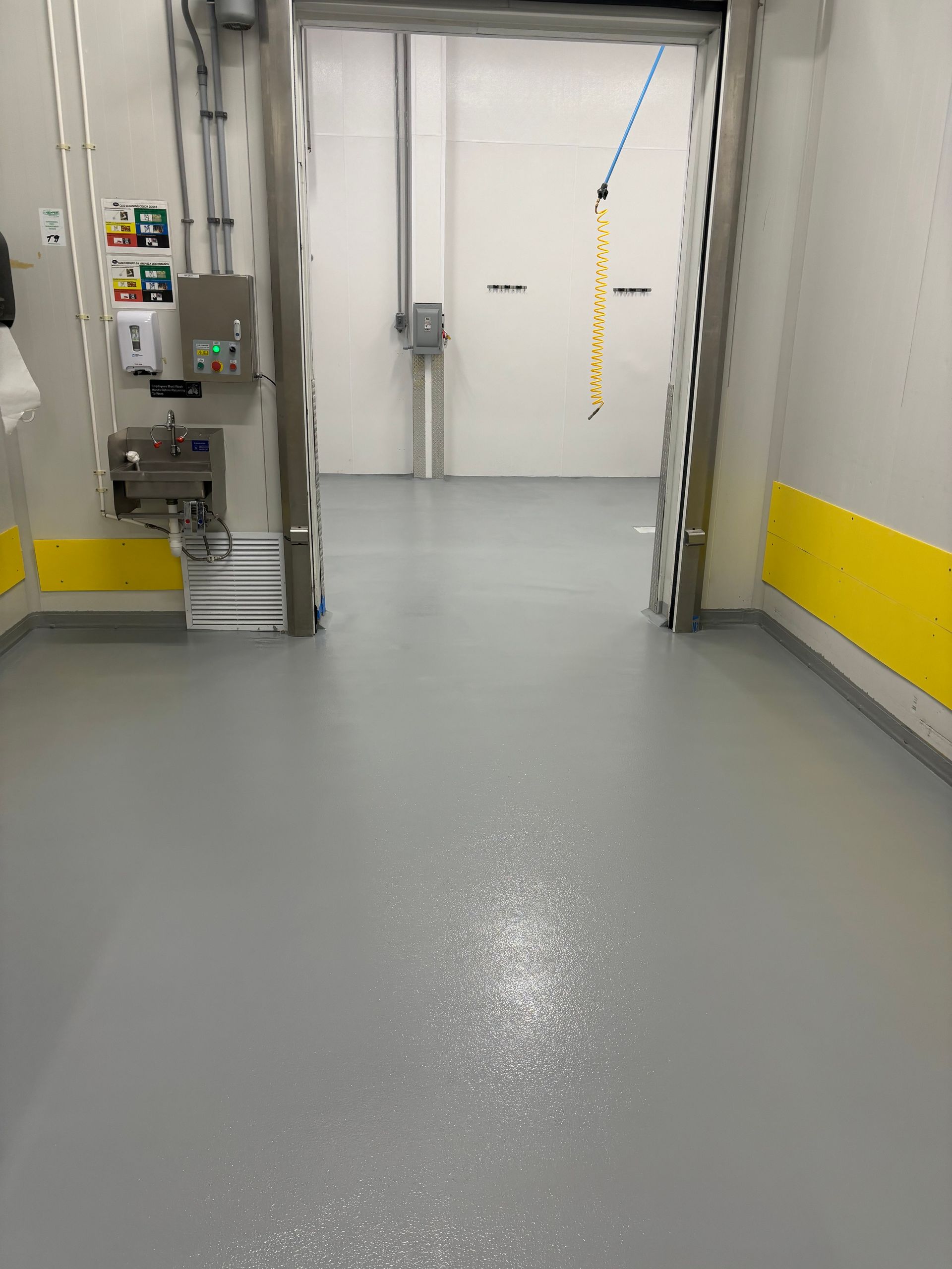 A room with a gray floor and yellow walls.