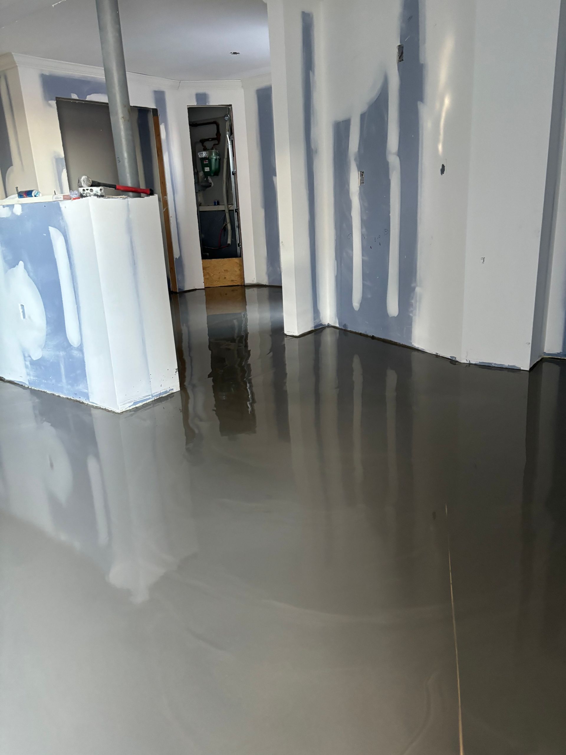 A room with a concrete floor and white walls.