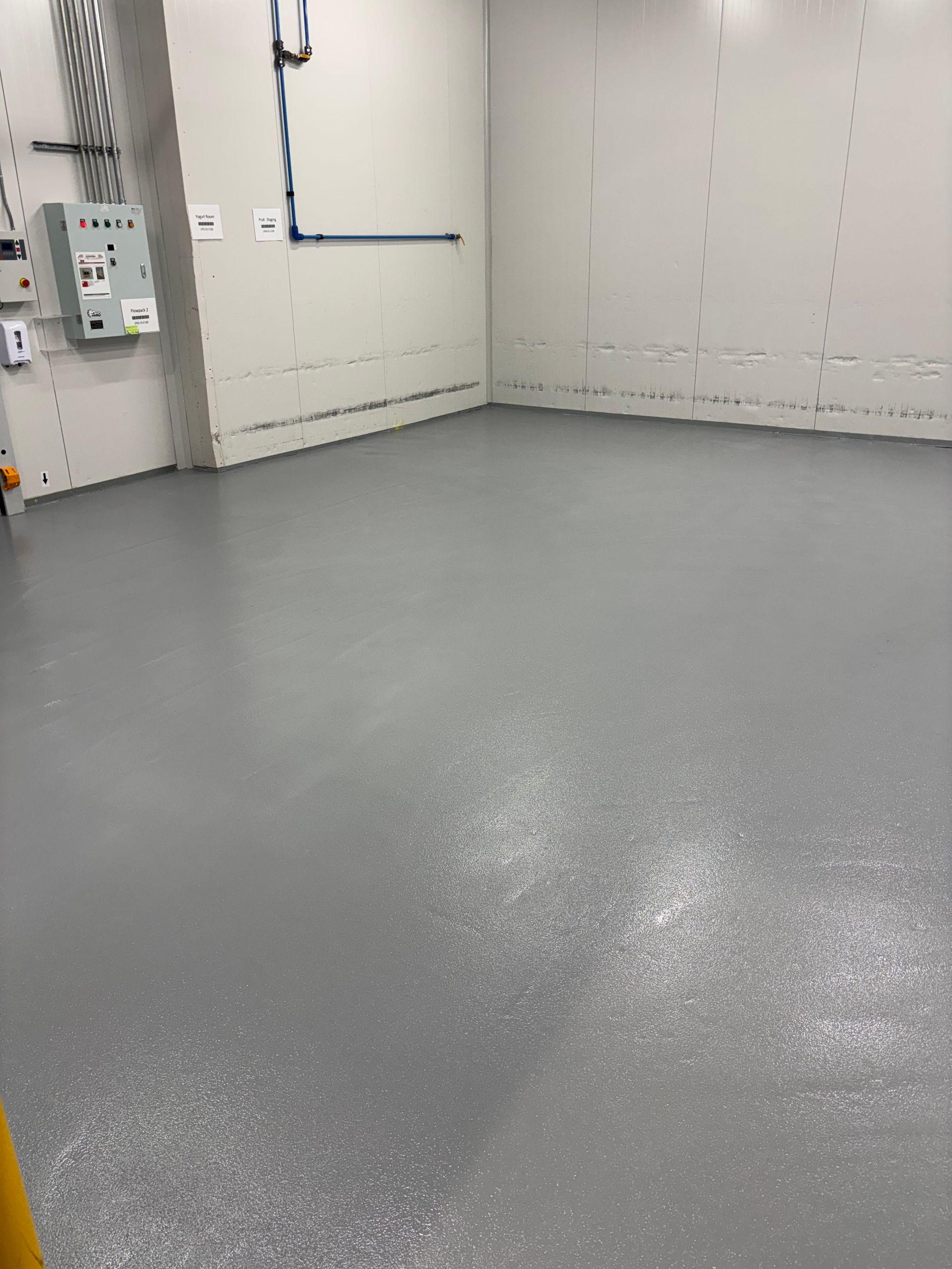 A room with a gray floor and white walls.