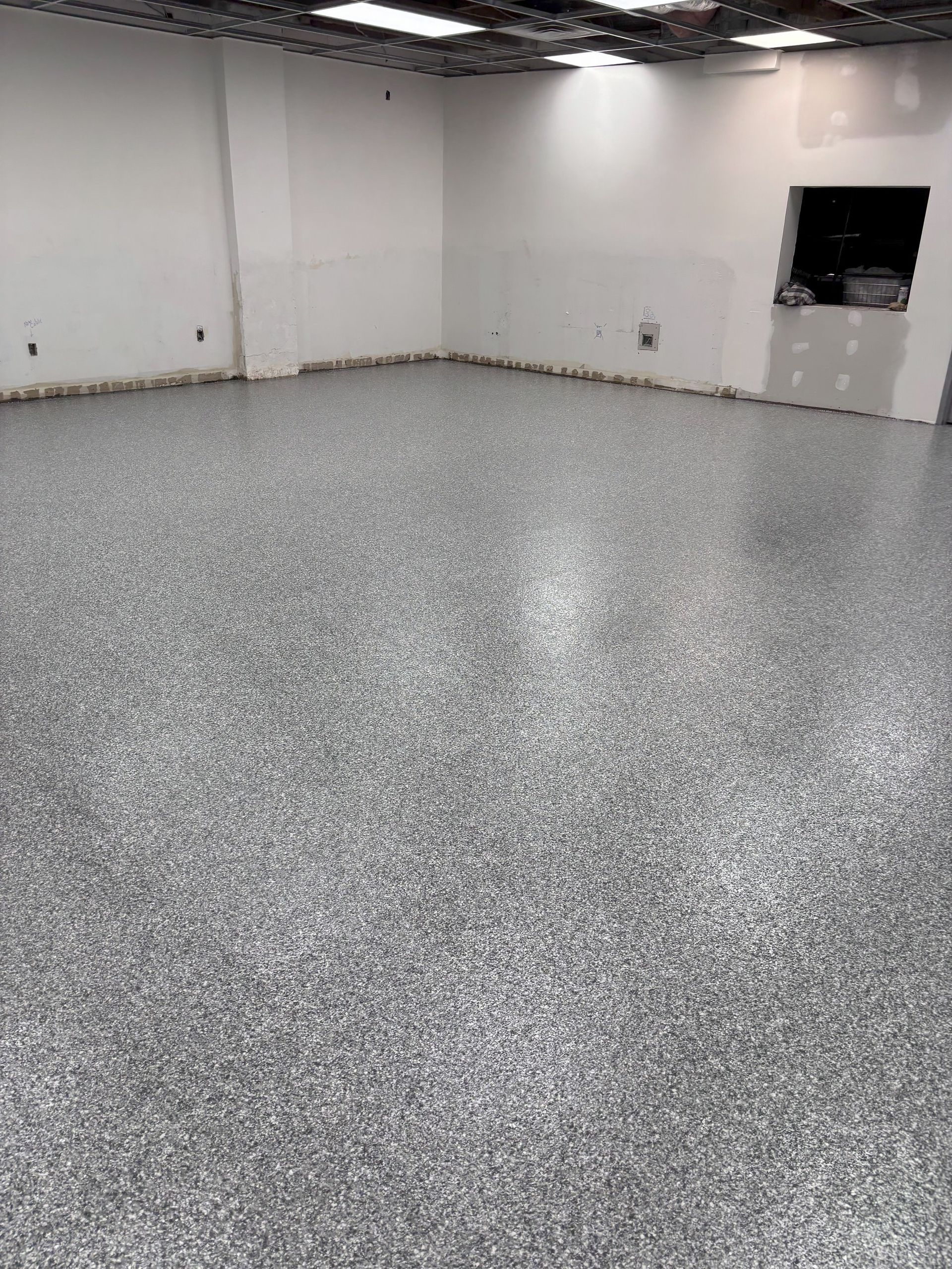 A large room with a gray floor and white walls.