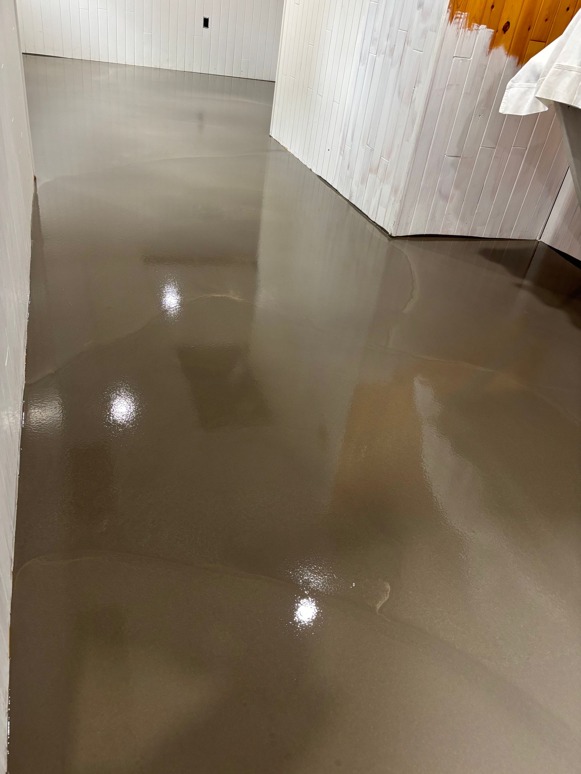 A room with a concrete floor and white walls.