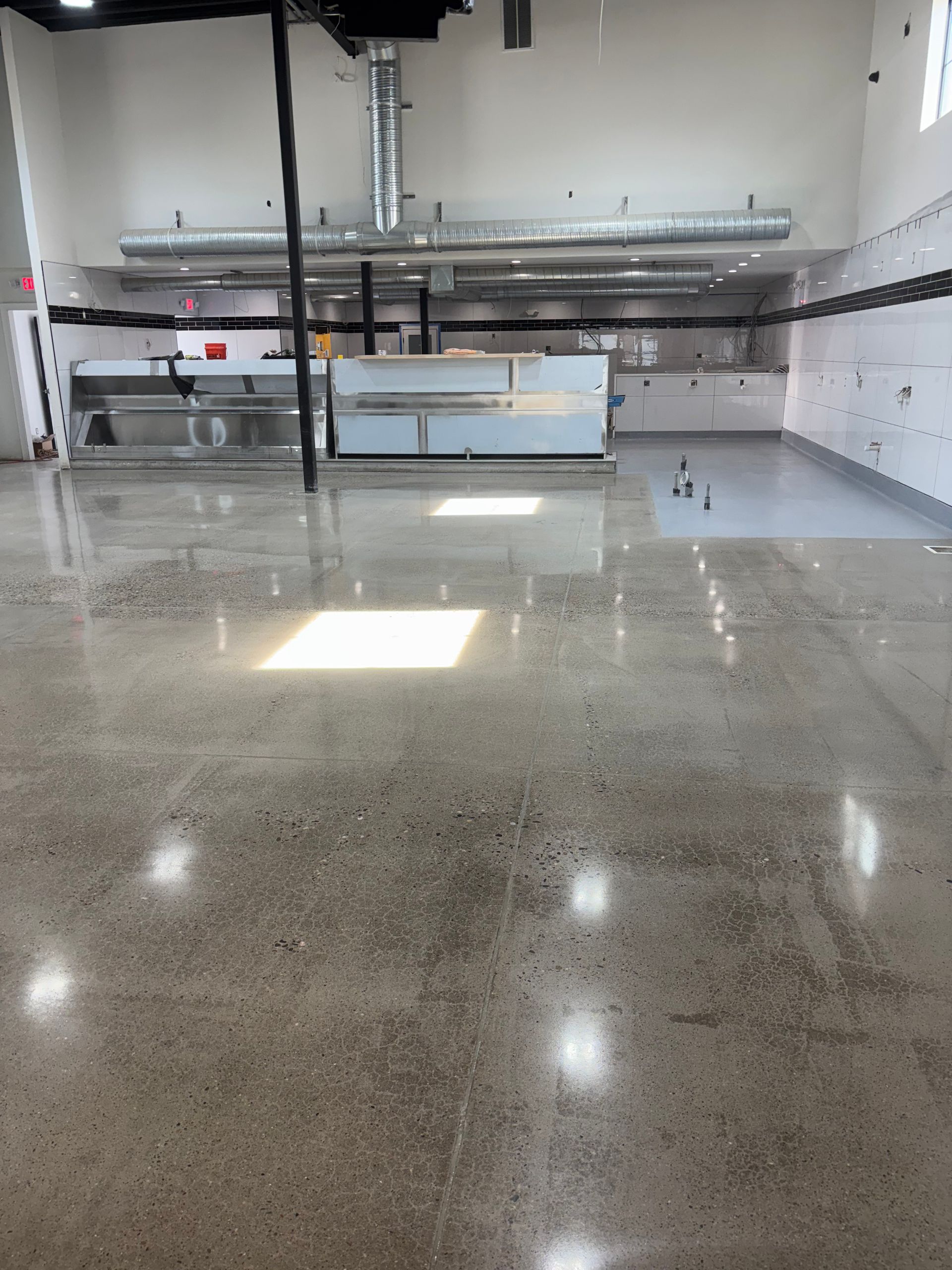 A large empty room with a shiny concrete floor