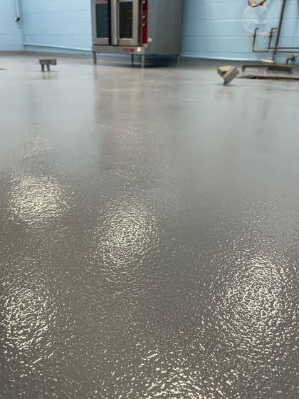 A kitchen floor with a oven in the background