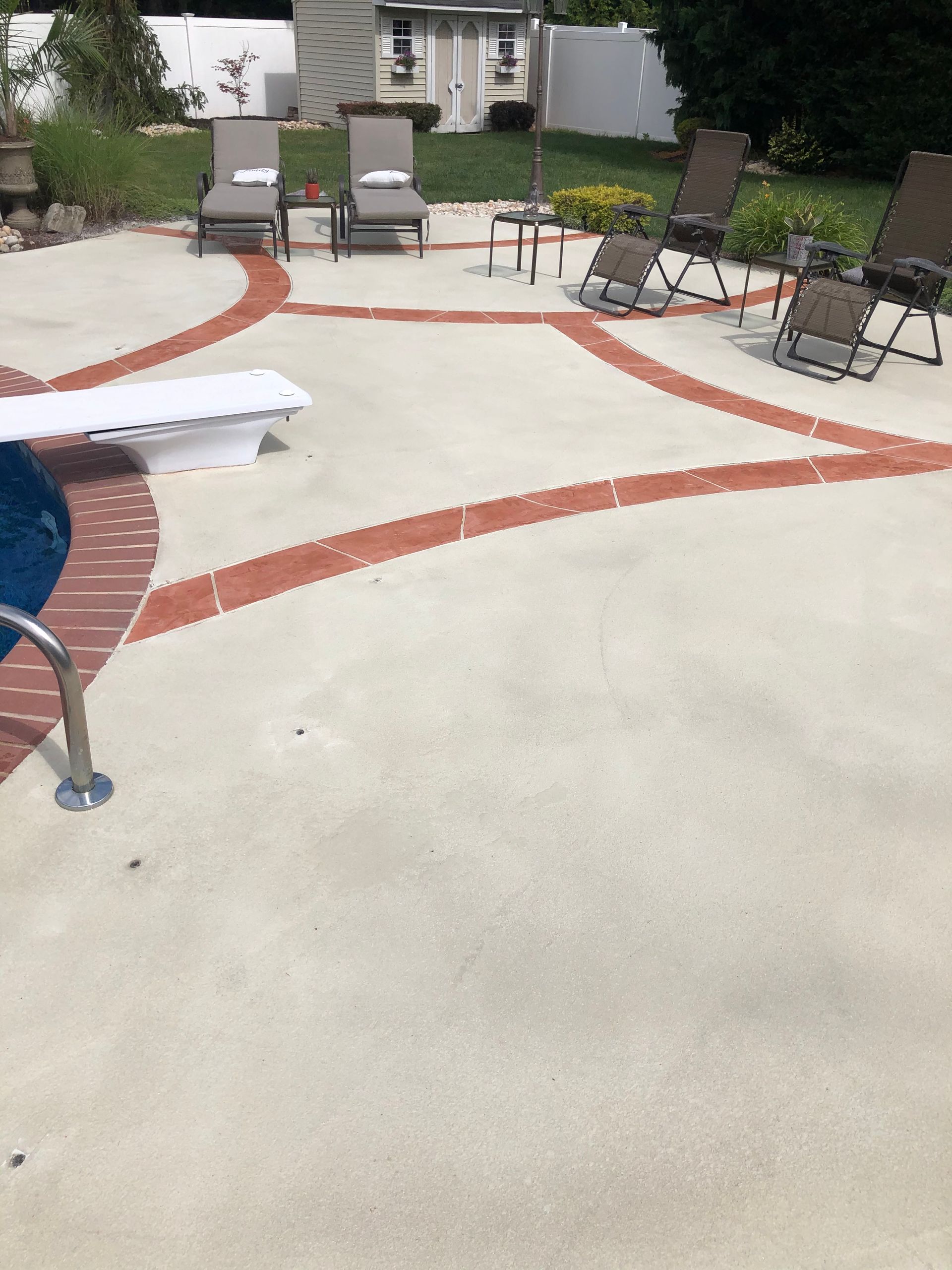 A patio with chairs and a table in the shape of a baseball.