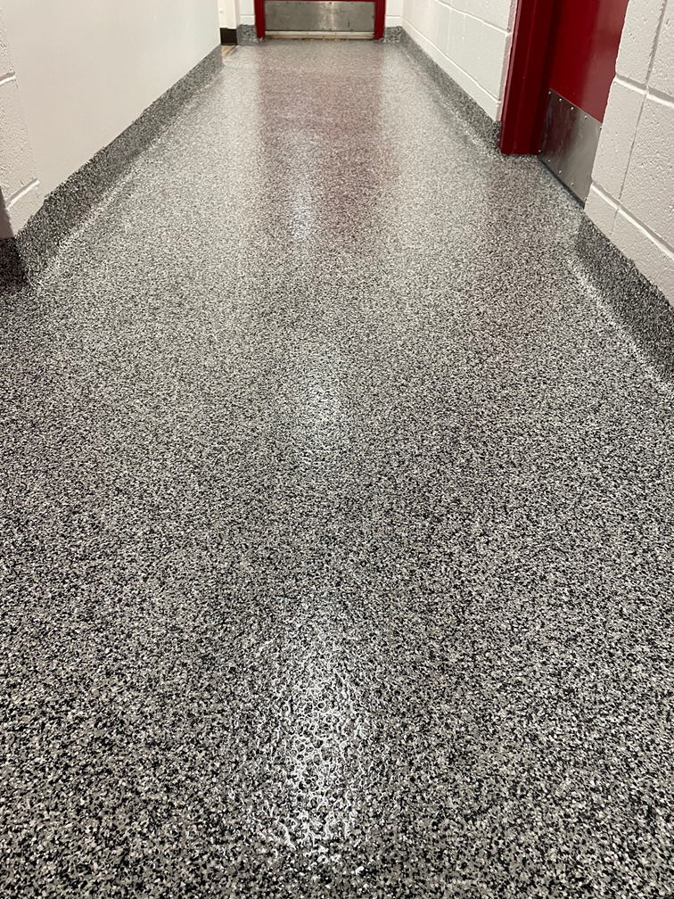 A close up of a cracked concrete surface.