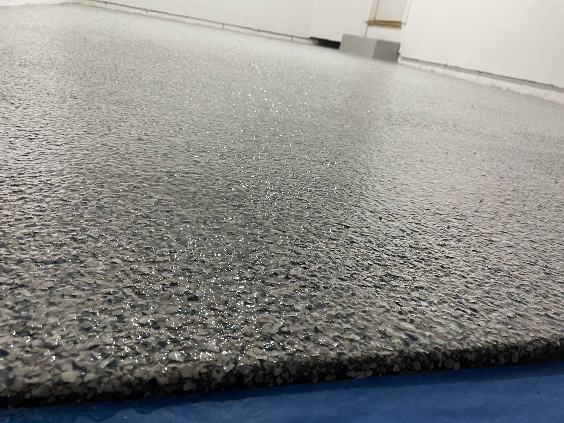 A close up of a painting of a river with a reflection of a mountain in the water.