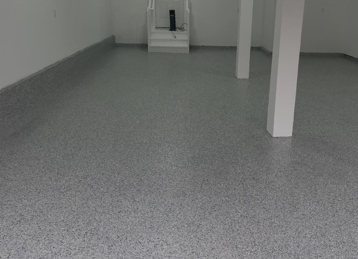 A room with a concrete floor and a wall.