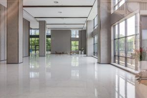 A large empty room with a lot of windows and columns.
