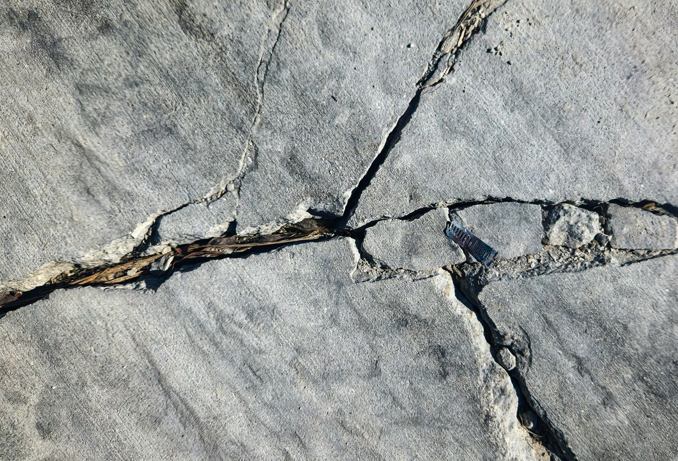 A close up of a painting of a river with a reflection of a mountain in the water.