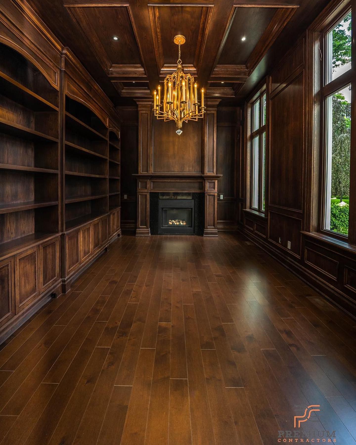 Man in black shirt holding coffee mug, smiling in a kitchen.