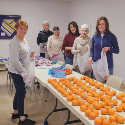 Volunteers prepare bagged meals for our Backpack Program. 