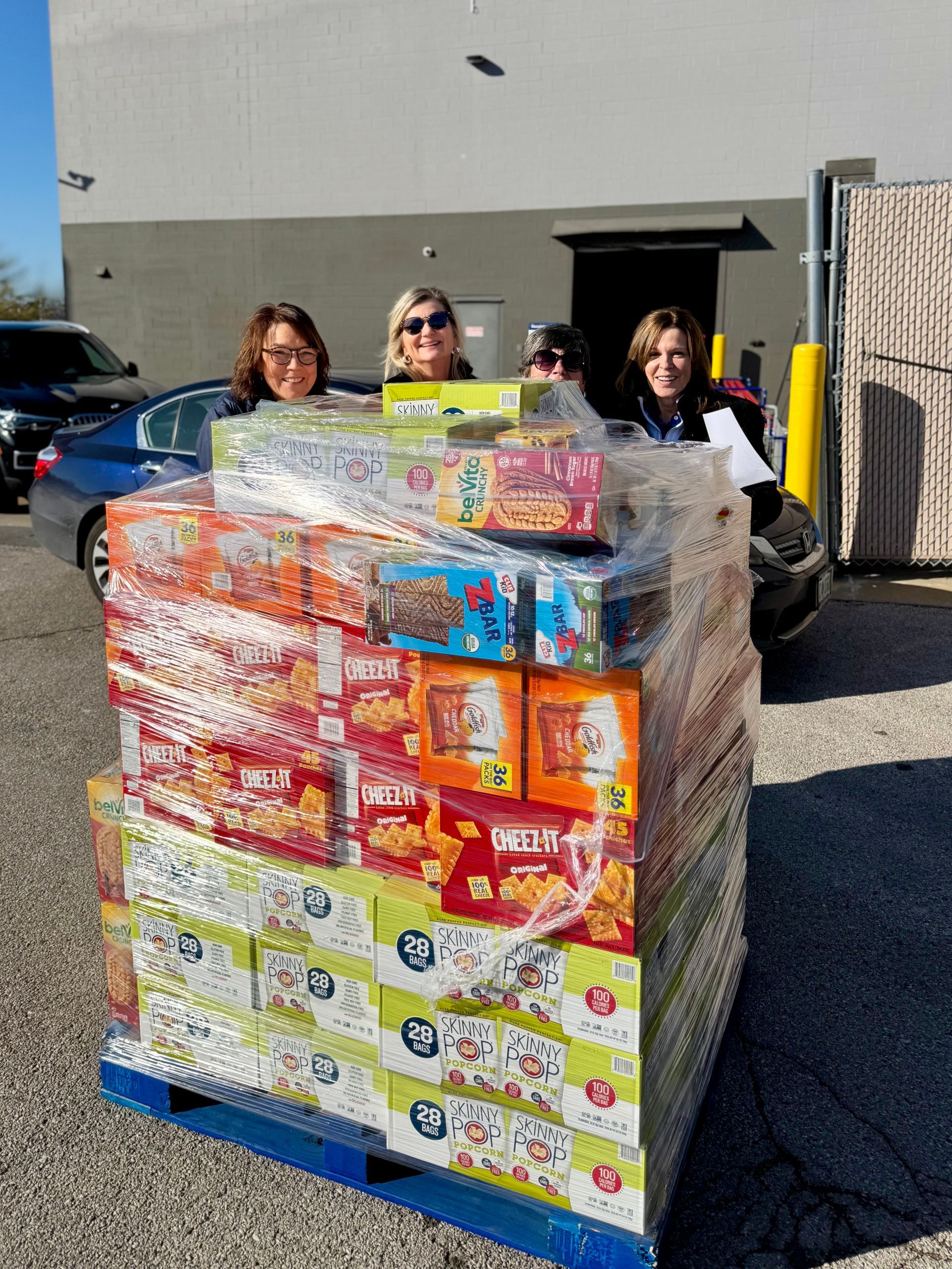 Backpack Program volunteers picking up snacks for students.