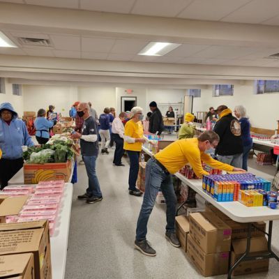 People sorting food at tables at Isaiah 58 Ministries.
