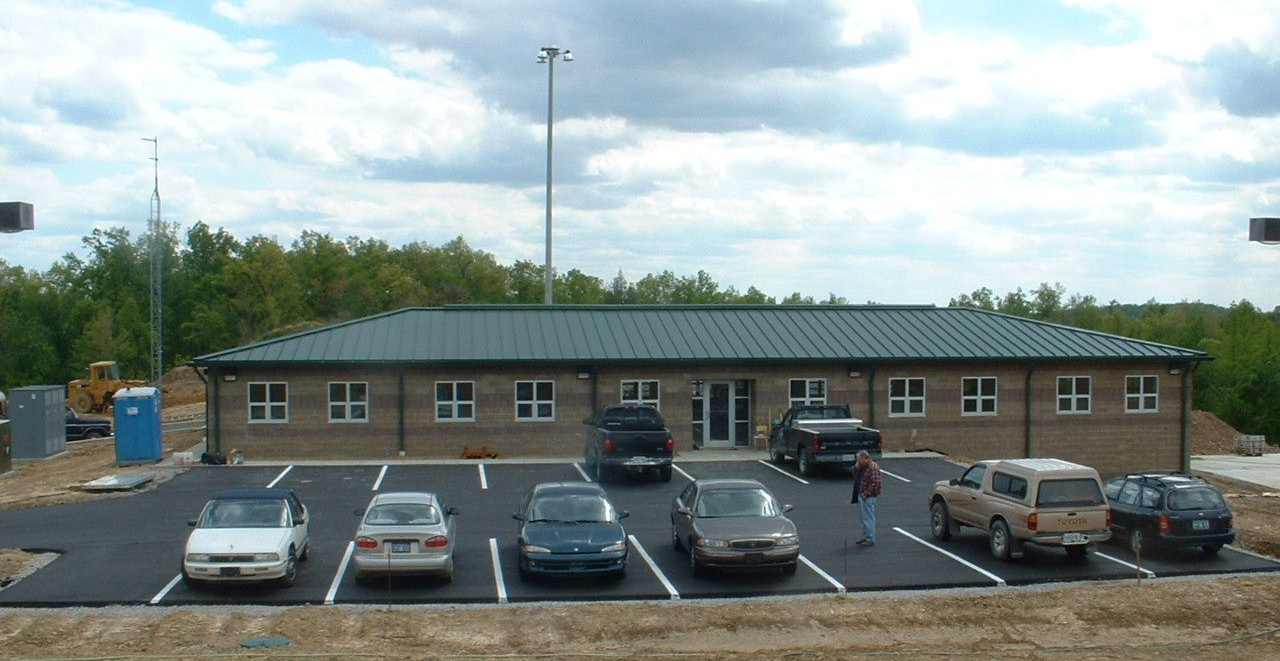 a parking lot laying in front of a building ad around a construction zone