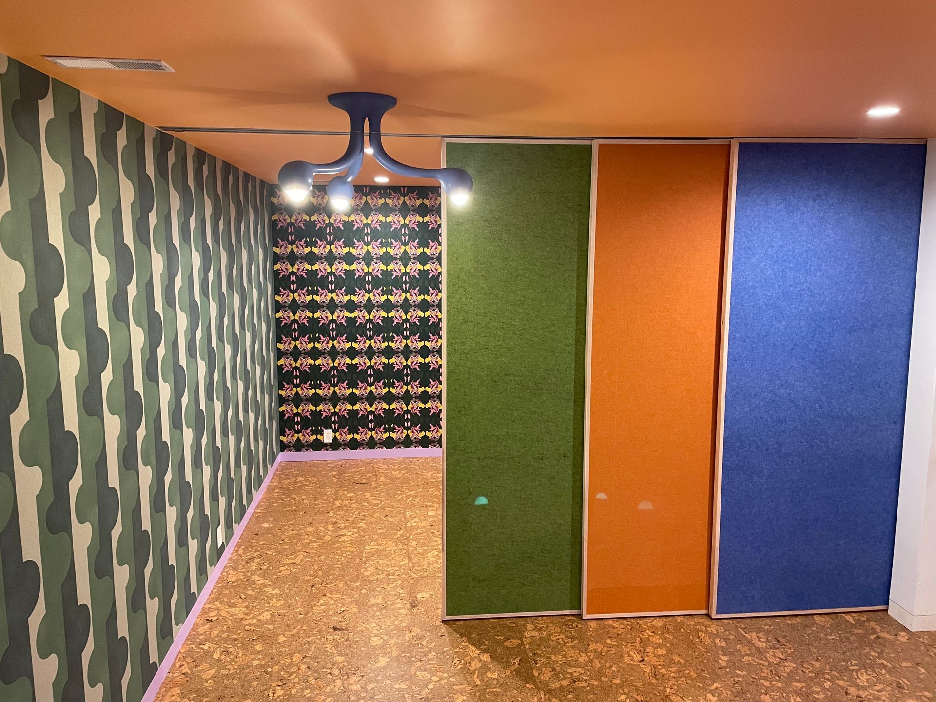 A room with a ceiling fan and a few sliding doors