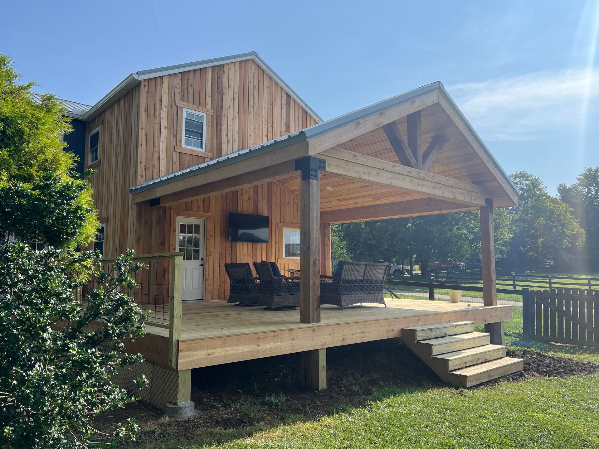 A wooden house with a large porch and stairs