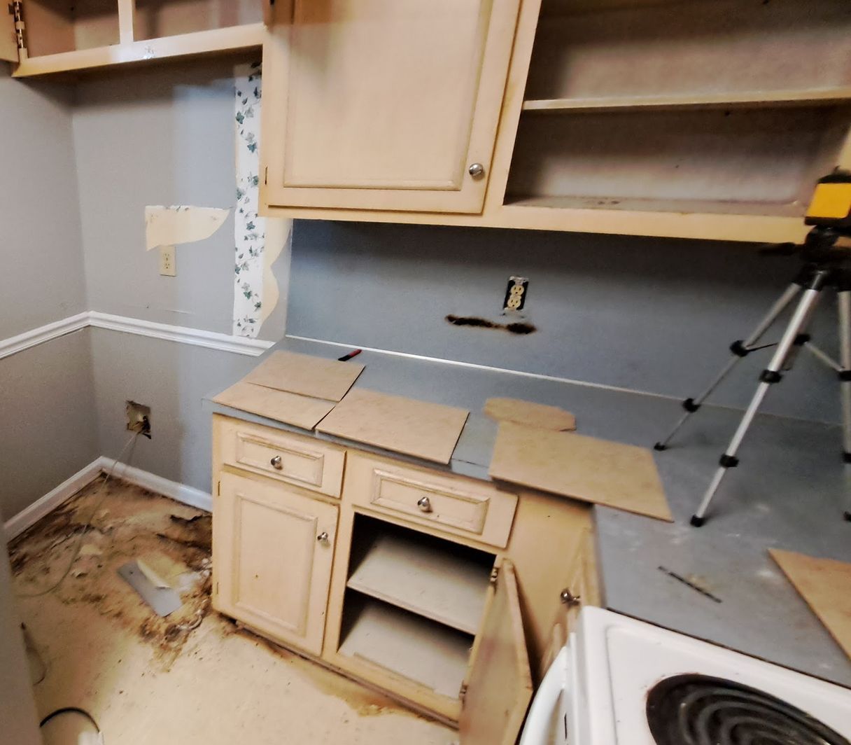 A kitchen with a stove and cabinets being remodeled
