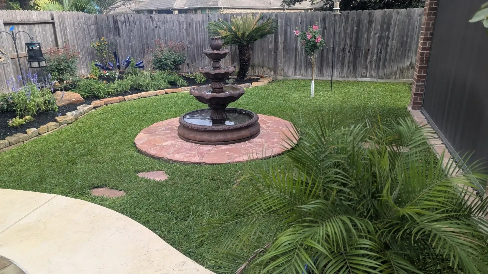 There is a fountain in the middle of the lawn.