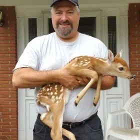 Man holding a baby deer — Poughkeepsie, NY — The Gutter Guy