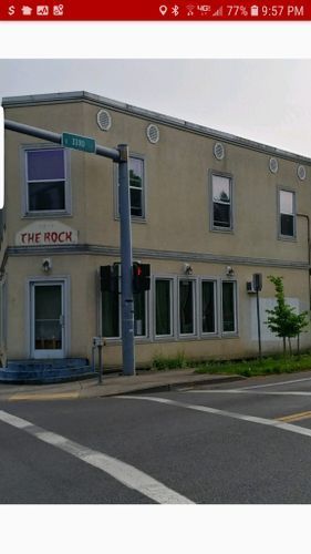 A building with a sign that says the rock on it