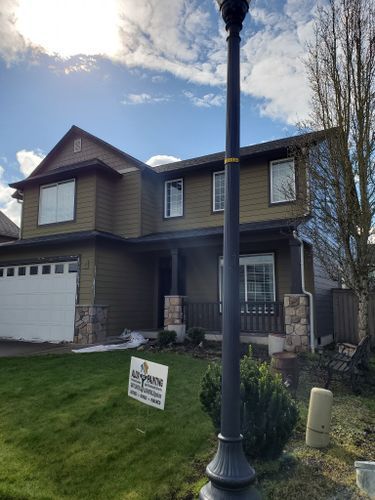 A large house with a for sale sign in front of it.
